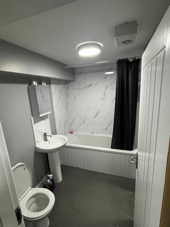 Un baño con inodoro, bañera y lavabo. en Spacious Modern flat Blackburn, en Blackburn