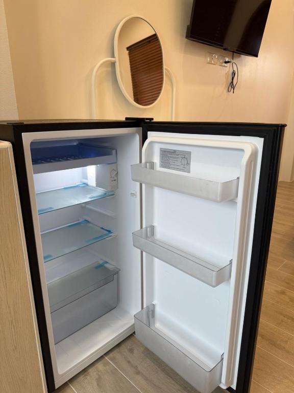 an empty refrigerator with its door open in a kitchen at Minimal Apartment in Central of city Near Central 1 km in Nakhon Pathom