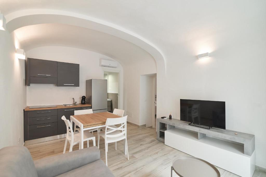 a kitchen and dining room with a table and chairs at AM8 - Cozy apartment in the center in Perugia