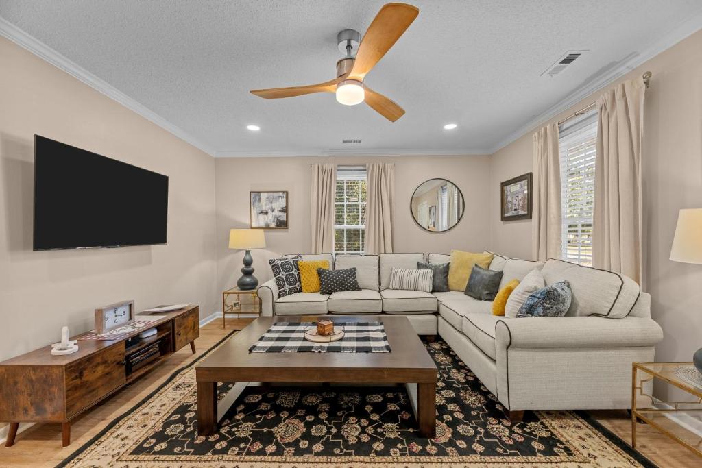 a living room with a couch and a ceiling fan at Pet-Friendly 3 BR Home with King Bed and Fenced Yard Near Downtown in New Bern