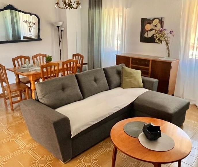 a living room with a couch and a table at Holiday Vintage Apartment in San Pedro del Pinatar