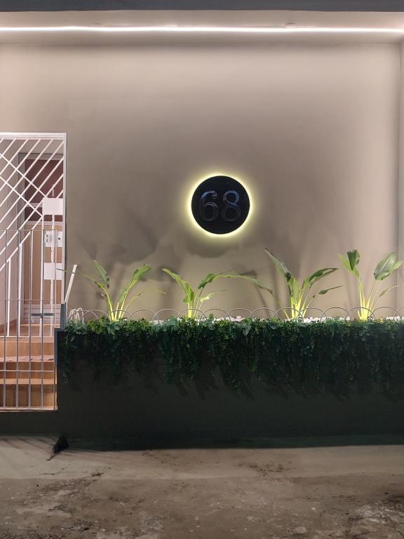 a light on the side of a building with plants at Studio 101 Cop 30 in Belém