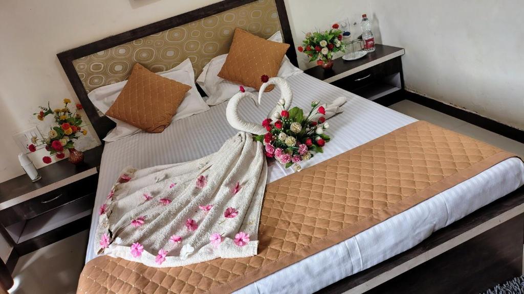 a bedroom with a bed with flowers on it at Stay Classy Inn in Mahabaleshwar