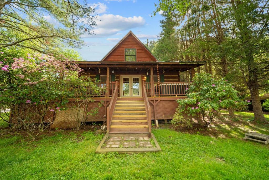 a house with a staircase leading up to the front door at Bridgepoint Cabin in Banner Elk