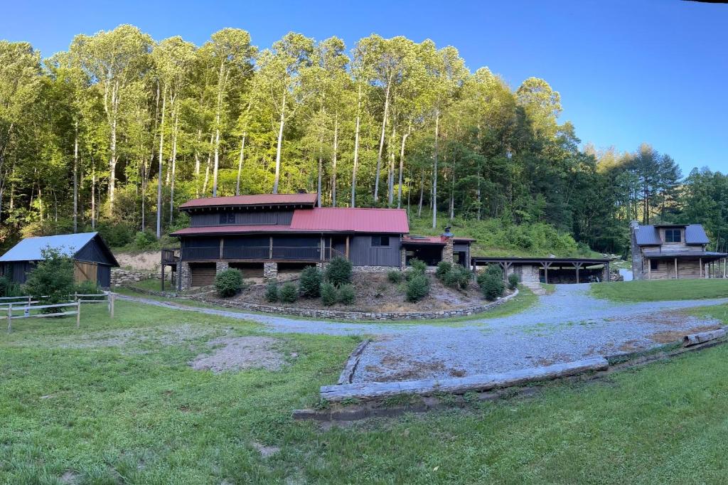 a house in the middle of a field with trees at Wagon Gap Trail: Lodge Lórien in Canton