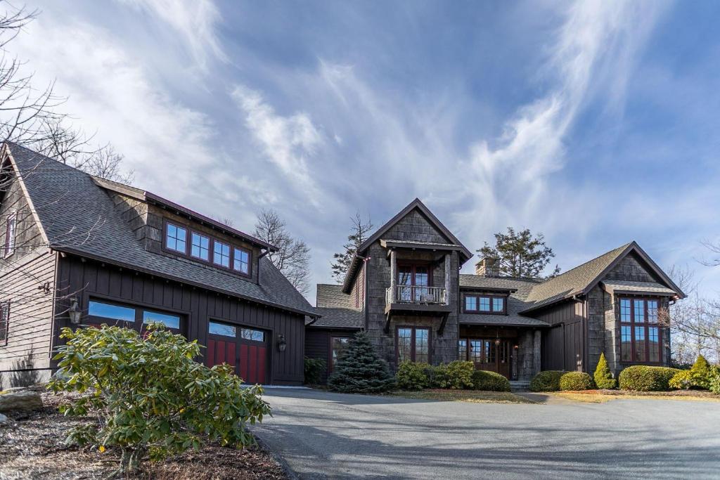 a large black house with a garage at Elk Camp Lodge in Linville