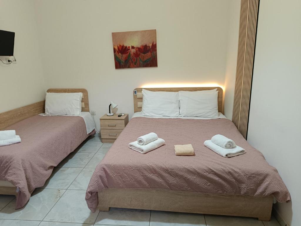 a bedroom with two beds with towels on them at Ζ&Ζ Studios in Perea