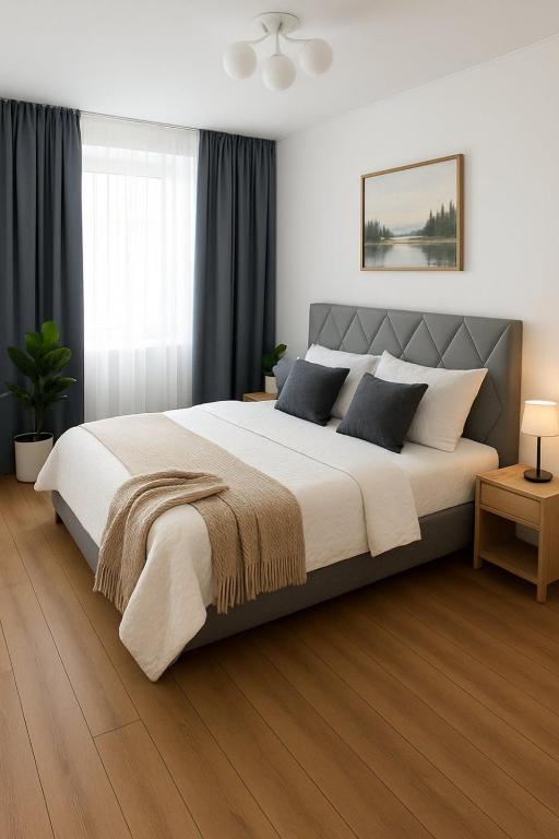 a bedroom with a large bed in a room at Стрийська Арена King Cross Автовокзал Новобуд in Lviv