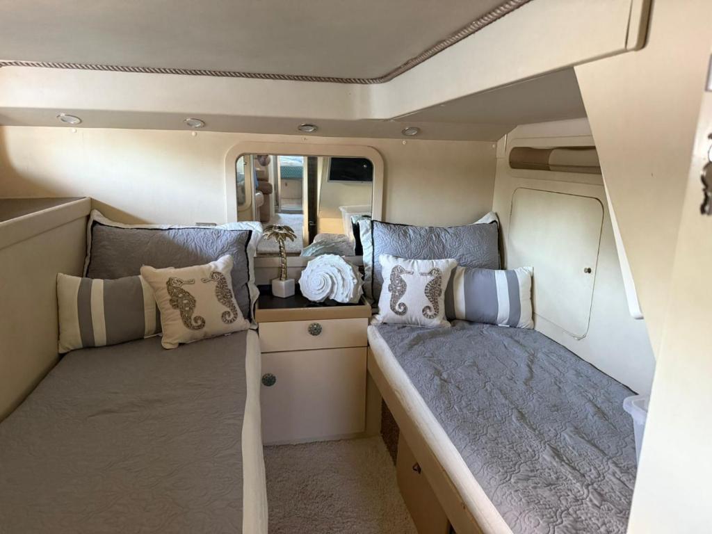 a bedroom in an rv with two beds and pillows at punta excursiones the king of kings in Punta Cana