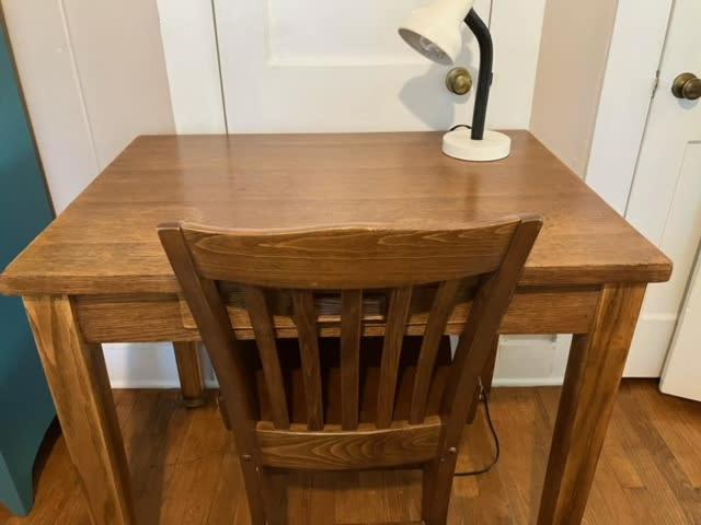 a wooden desk with a chair and a lamp on it at Bright 1BR Hideaway Close to UL Lafayette in Lafayette