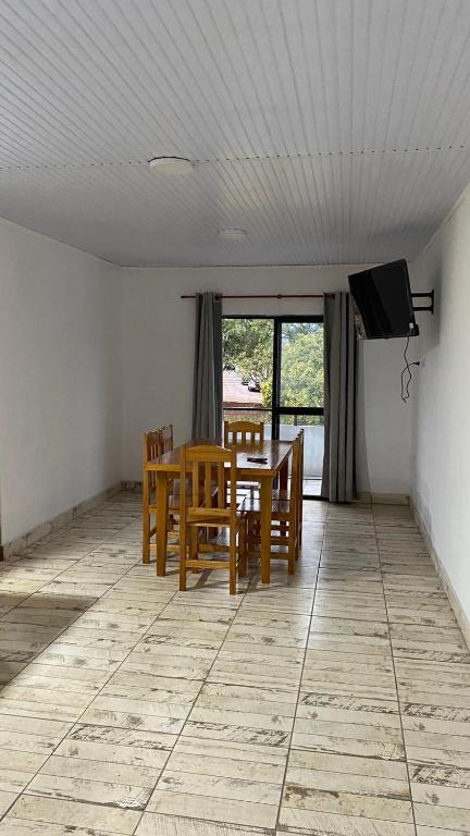 a dining room with a table and chairs and a television at dpto todo limpieza in San Vicente