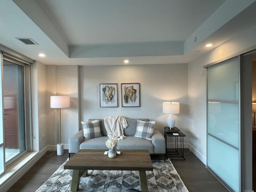 a living room with a couch and a table at Downtown bright cozy & modern 1 Bedroom in Halifax