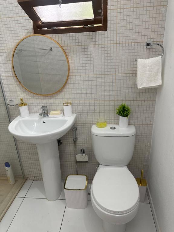a bathroom with a sink and a toilet and a mirror at T2 Vacation in Mindelo in Mindelo