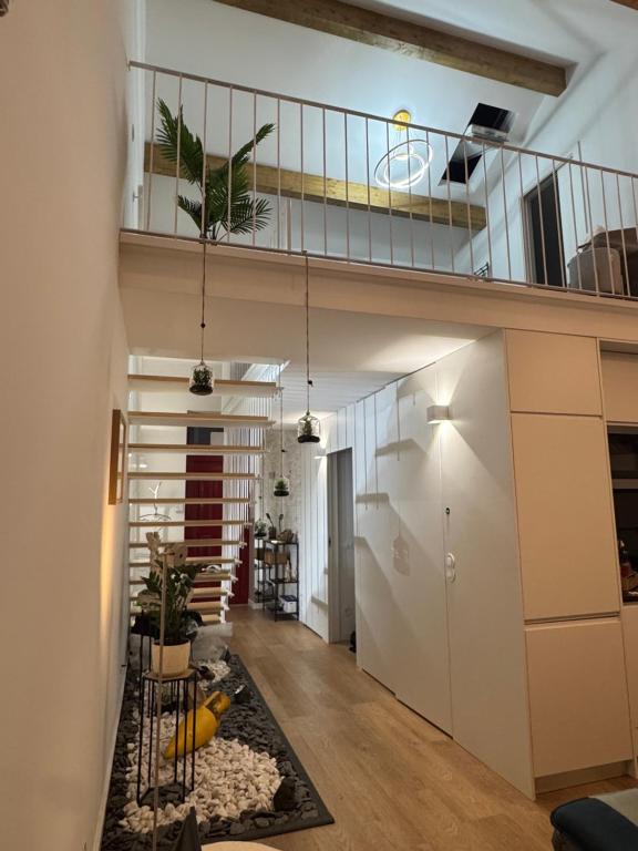 a hallway of a house with a staircase and a living room at CreaConfort Casa Boa Jóia de Campanhã in Porto