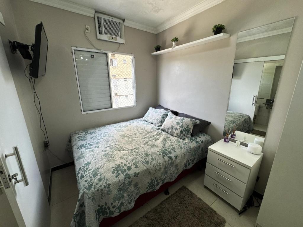 a small bedroom with a bed and a mirror at Ap Cop 30 in Belém