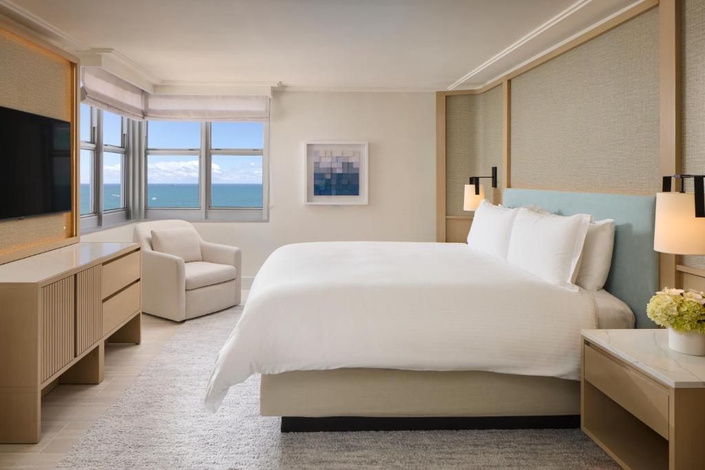 a bedroom with a large white bed and a television at Loews Miami Beach Hotel in Miami Beach