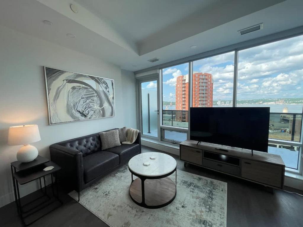 a living room with a couch and a flat screen tv at Waterfront downtown 1 Bedroom with 6 appliances in Halifax