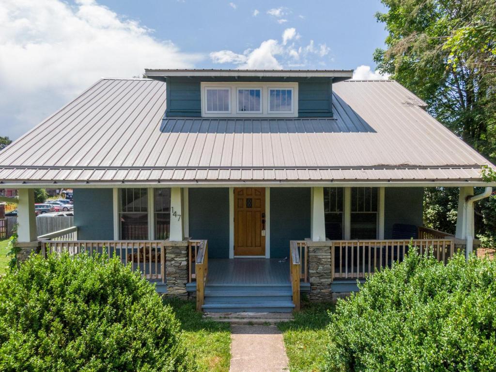 a blue house with a metal roof at Stella Maris in Blowing Rock