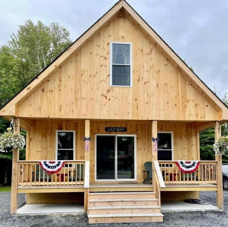 a log cabin with a gambrel roof at Cozy Secluded Cabin with Fire Pit and Barbecue in Greenville, Maine in Greenville