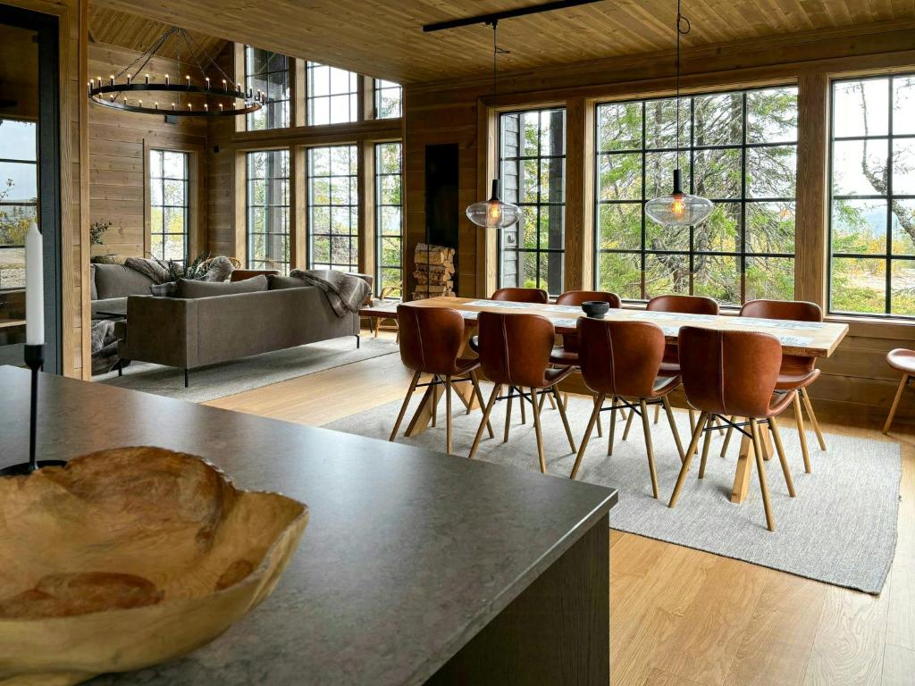 a large living room with a table and chairs at Mountain Cabin With Views Over Jämtland's Expanse in Storhågna