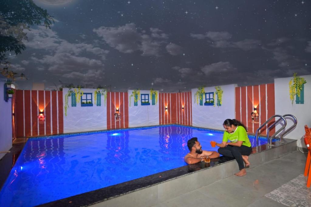 een vrouw en een kind naast een zwembad bij ll EMPYREAN STAY ll AIRAWAT VILLA ll 2BHK llAC ll PRIVATE POOL ll LUXE ll in Lonavala