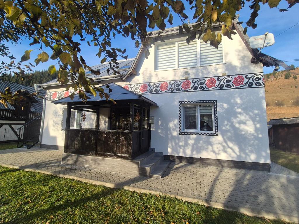 a white building with a window on the side at Casa Dumitru si Elena Ciocanesti Bucovina in Ciocăneşti