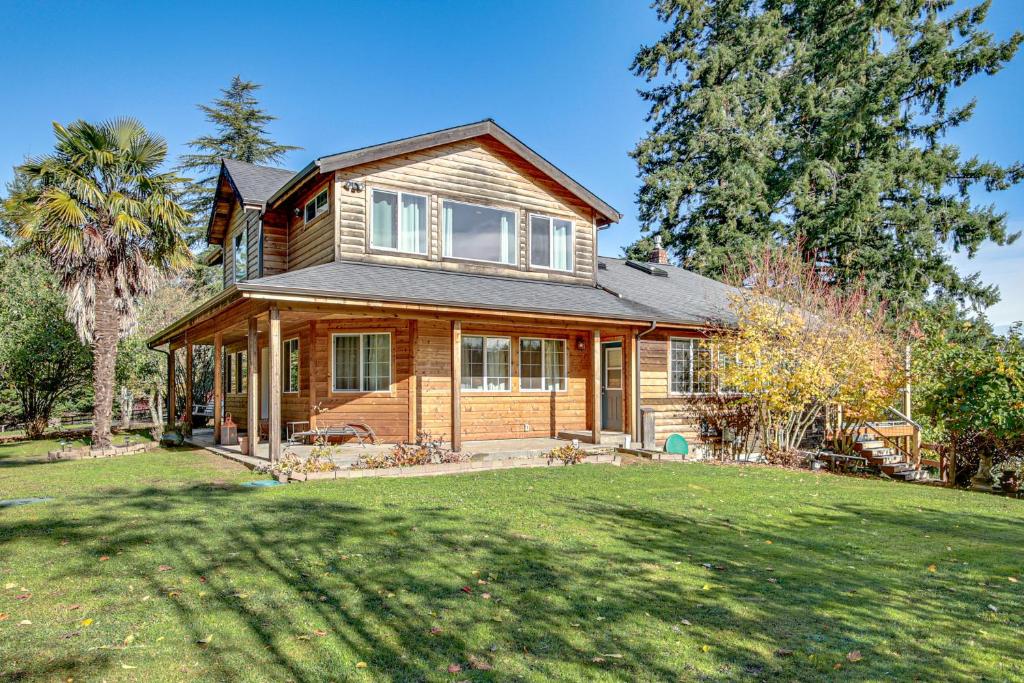 a large wooden house with a large yard at Hikes and Apples Renovated Farmhouse in Gig Harbor! in Rosedale