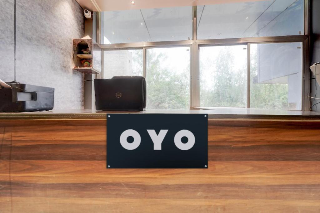 a sign sitting on a table in a room at HOTEL O AWARA GRAND PALACE in Pratāpgarh