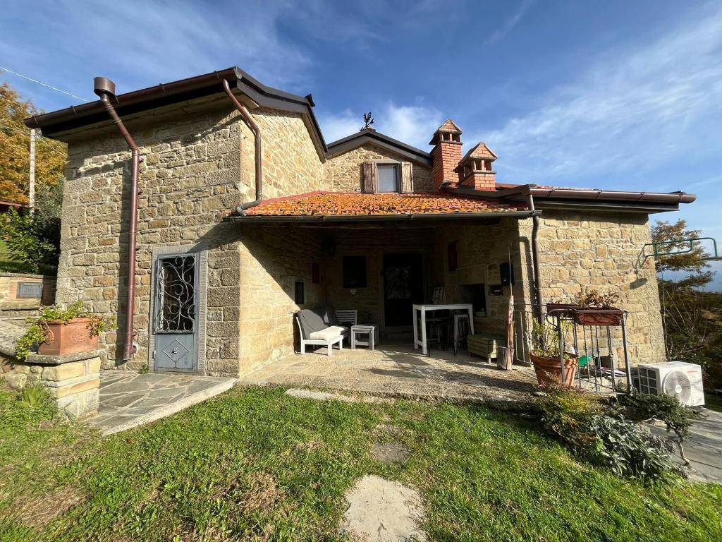 a small stone house with a patio in front of it at Casa Martino in Villa