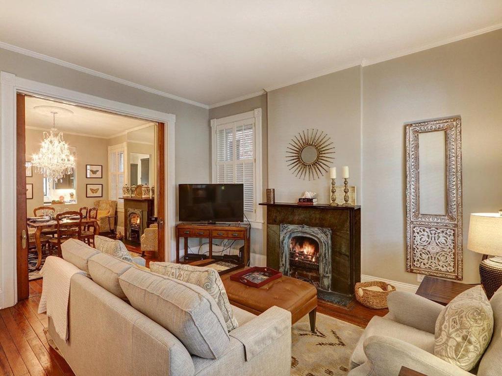 a living room with a couch and a fireplace at Luxury on Lincoln in Savannah