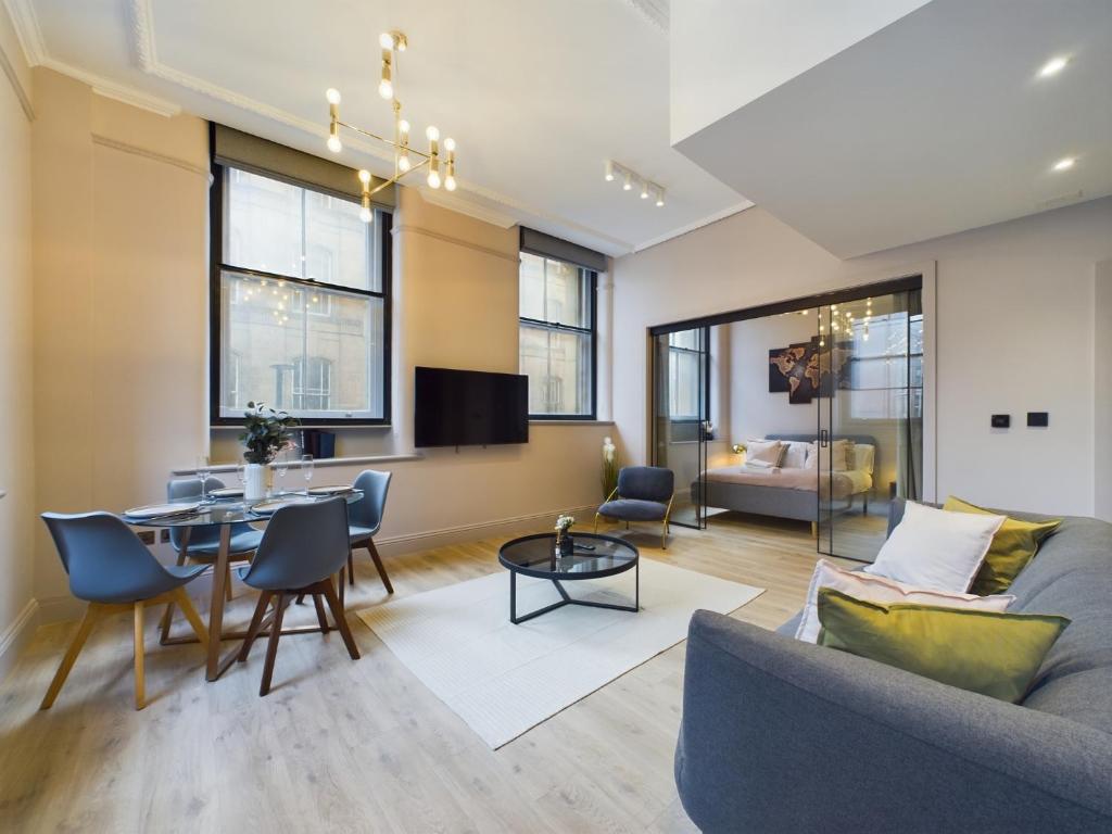 a living room with a couch and a table at Luxury Unique 2bedroom city centre in Manchester