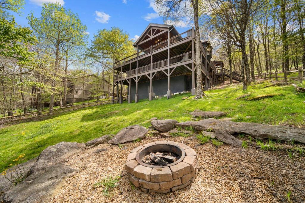 a fire pit in front of a house at Sit Stay Play in Beech Mountain
