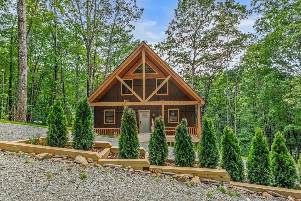 a log cabin in the woods with trees at Bear Necessities in Beech Mountain