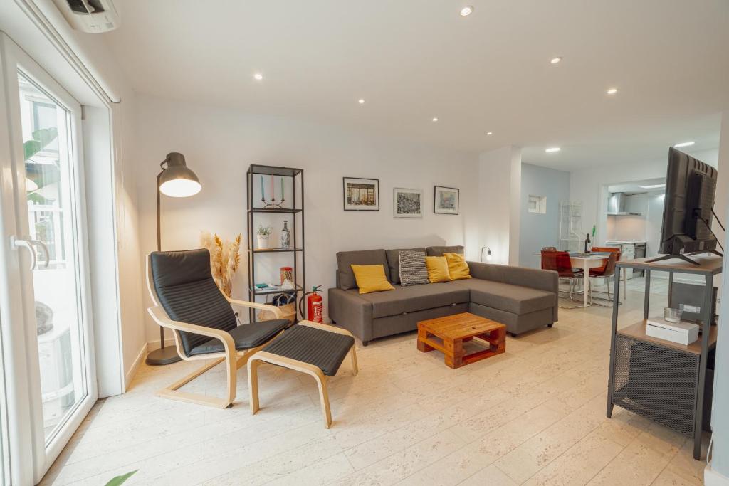 a living room with a couch and a table at Porto Window Terrace House by Vacationy in Bandeira
