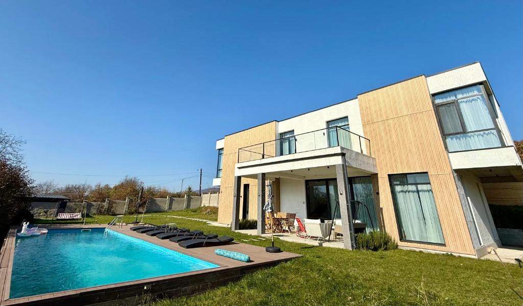 a house with a swimming pool in front of it at Villa Saguramo in Saguramo