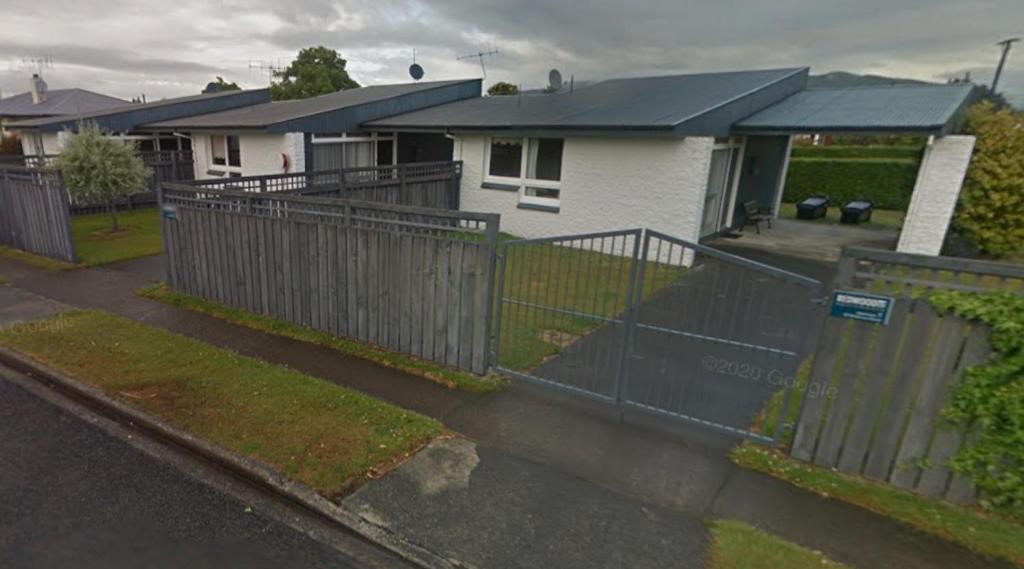 een hek voor een huis met huizen bij McKerrow St - 2 in Te Anau