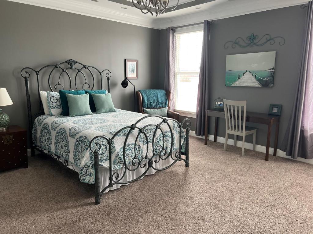 a bedroom with a bed and a desk and a chair at Palmer Room at The Inn, Occano Arnold Palmer Golf 