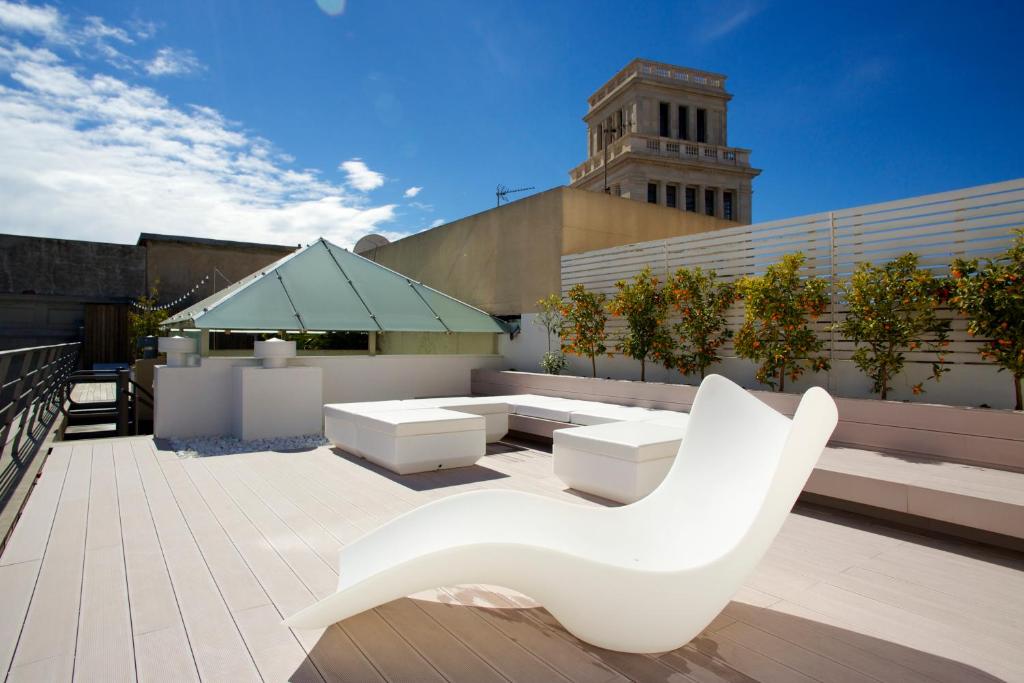una silla blanca sentada en la parte superior de un edificio en PG3 - Ático en Paseo de Gracia, en Barcelona