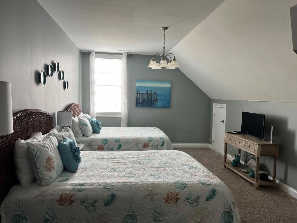 a bedroom with two beds and a television in it at Avoca Room at The Inn, Occano Arnold Palmer Golf Course 