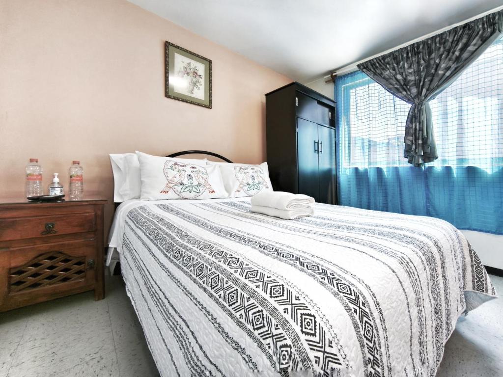 a bedroom with a large bed and a window at Nice bedroom at 5 min Mexico City Airport T1 & T2 in Mexico City
