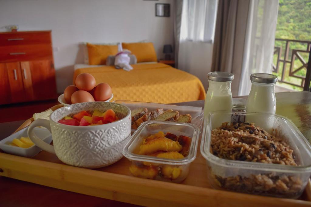 a tray with food and drinks on a table at Bungalows Paraíso Celeste in Bijagua