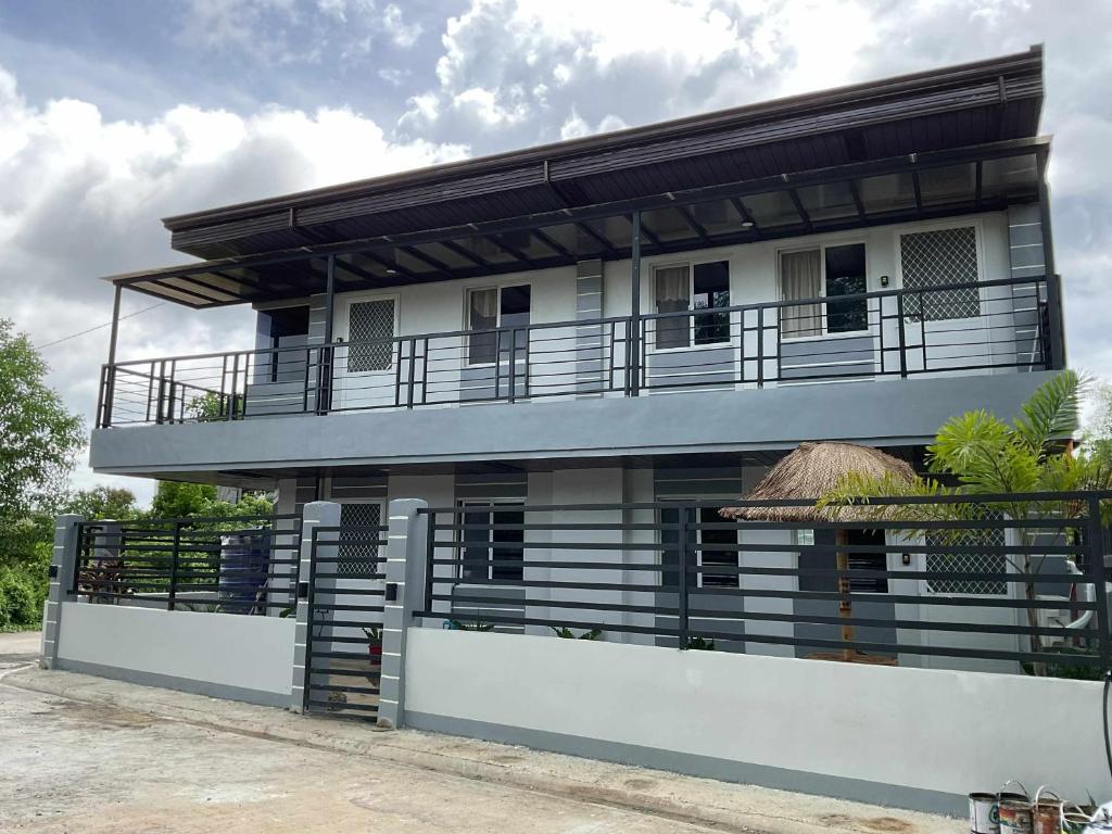 a building with a balcony on top of it at 2K2M Rental Units in Panglao