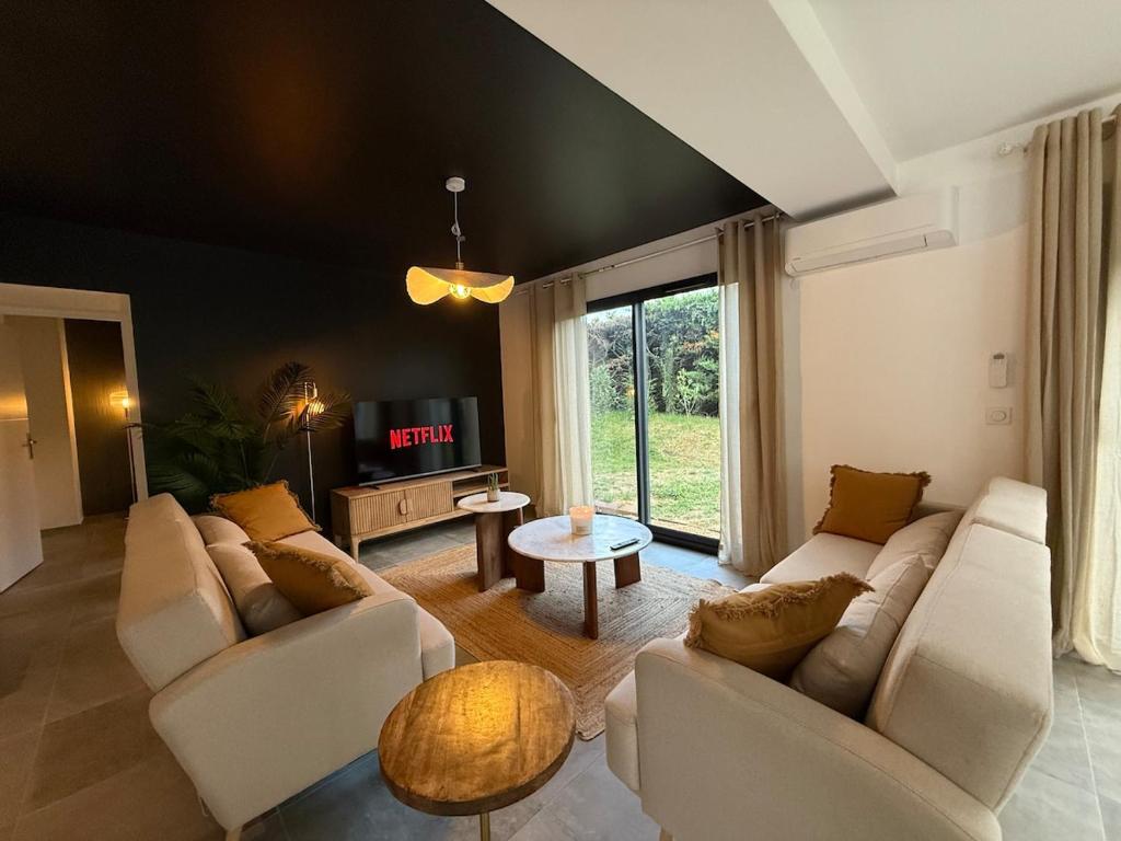 a living room with white couches and a tv at Modern house 4 bedrooms in Tassin-la-Demi-Lune