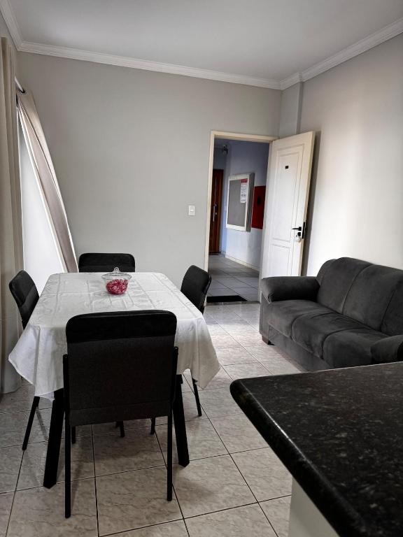 a living room with a table and a couch at Condominio Delville 2 quartos in Porto Velho