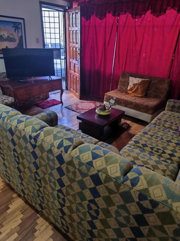 a living room with two couches and a piano at Minidepartamento central en Ambato, para 1 a 8 personas en 3 Camas y un colchon in Ambato