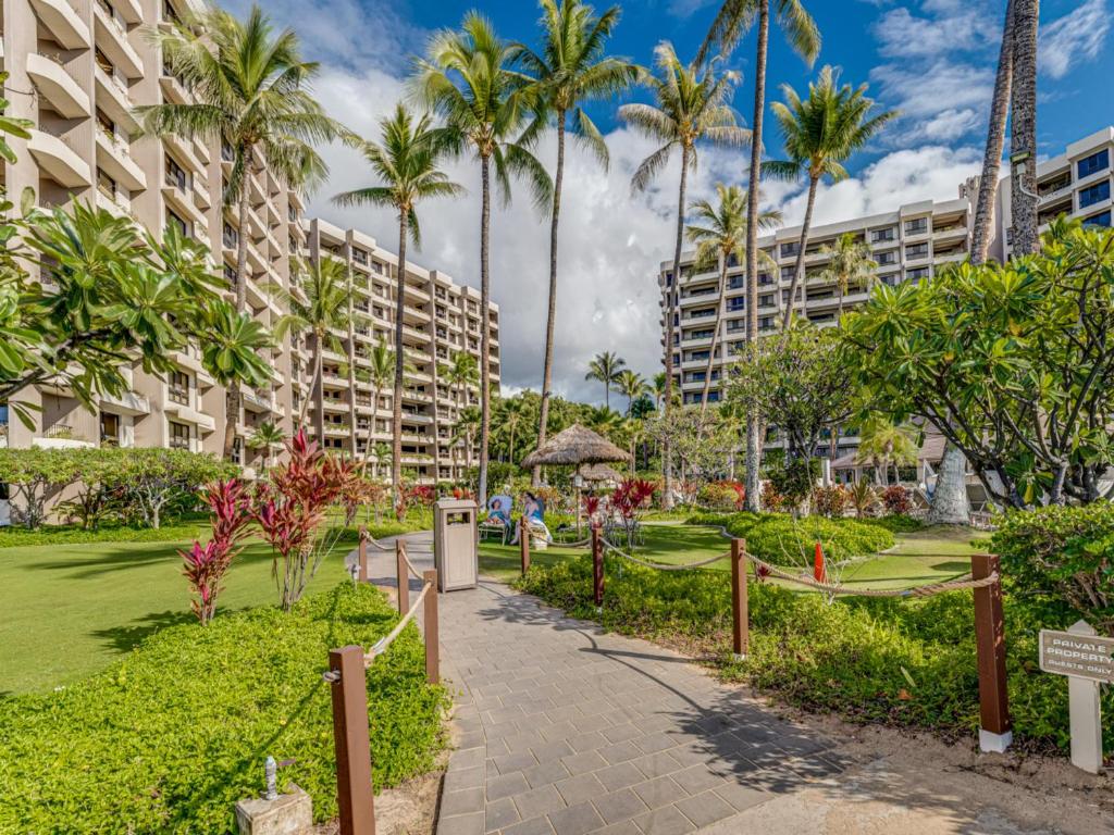a park with palm trees and a building at Kaanapali Alii 2 Bedroom Ocean View in Kaanapali