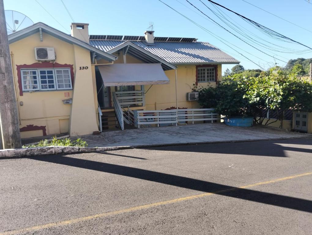 a yellow house with a ramp in front of it at kitnet xixo 02 in Gramado