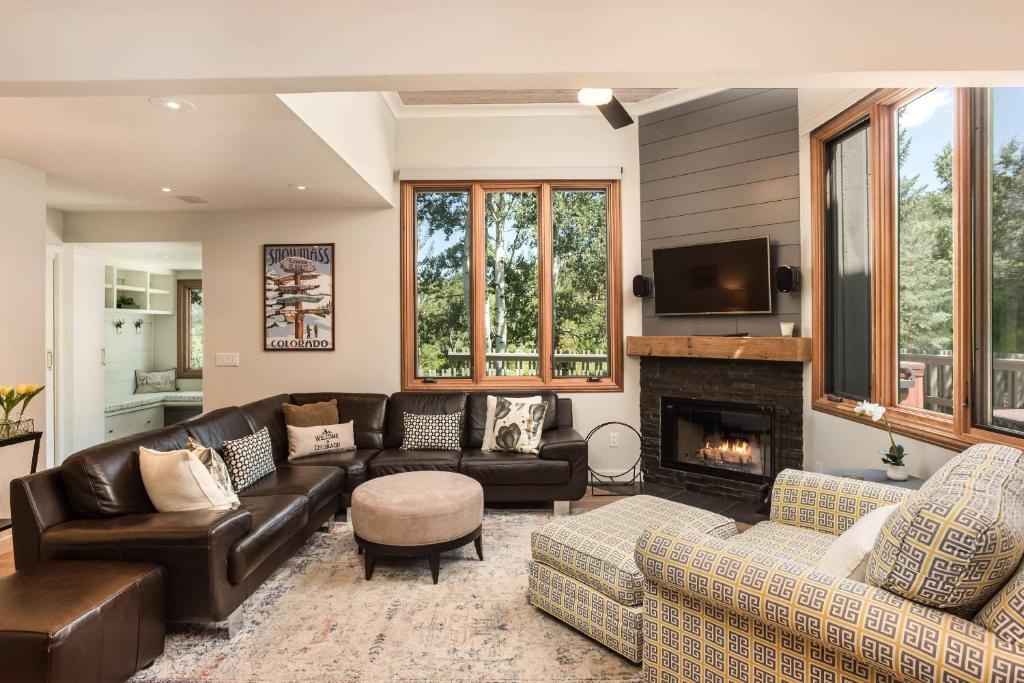a living room with a couch and a fireplace at Meadow Ranch 384 Private Outdoor Hot Tub in Snowmass Village