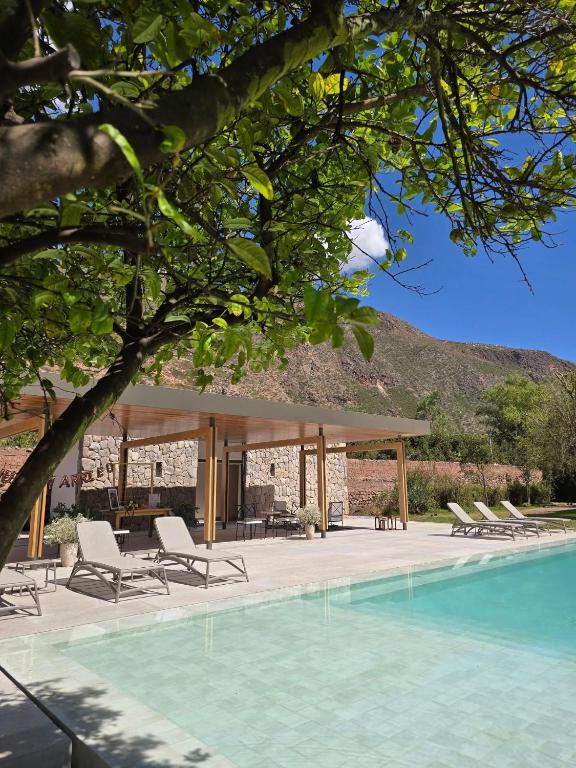 a pool with chairs and a gazebo at Hotel La Casona De Yucay Valle Sagrado in Urubamba