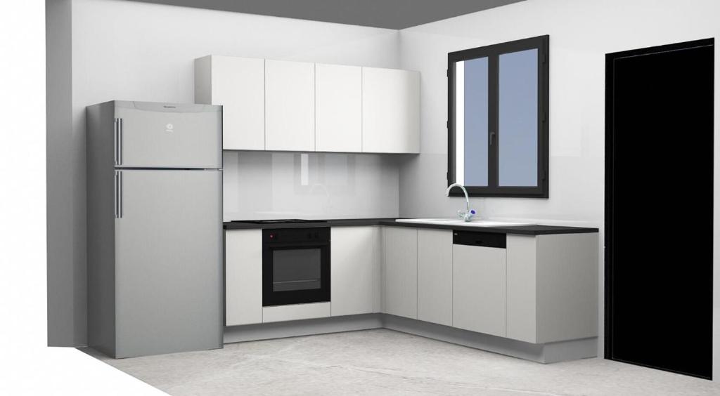 a kitchen with white cabinets and a refrigerator at Résidence Tunis Carthage in Ariana